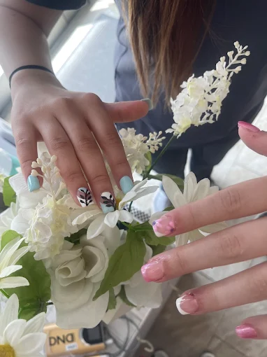 Two nail designs: mint green with botanical accents and pink french tips with glitter