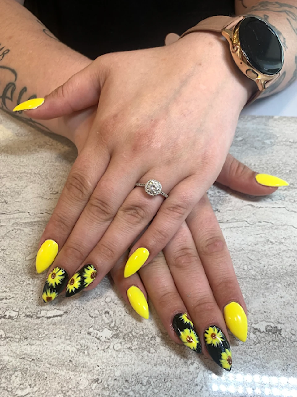 Yellow nails with sunflower accents