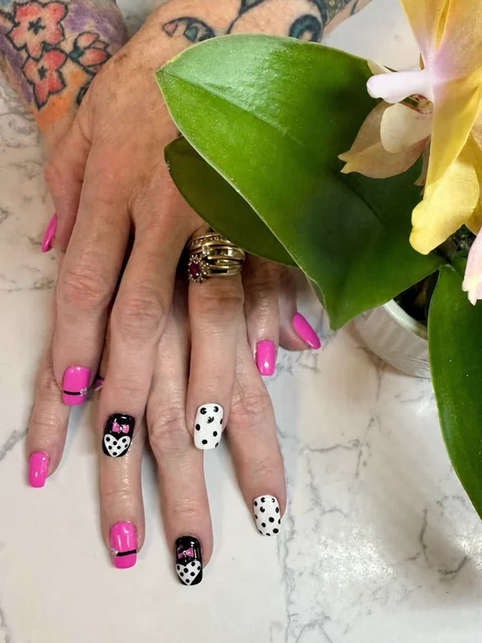 Pink, black, and white nail art with bows