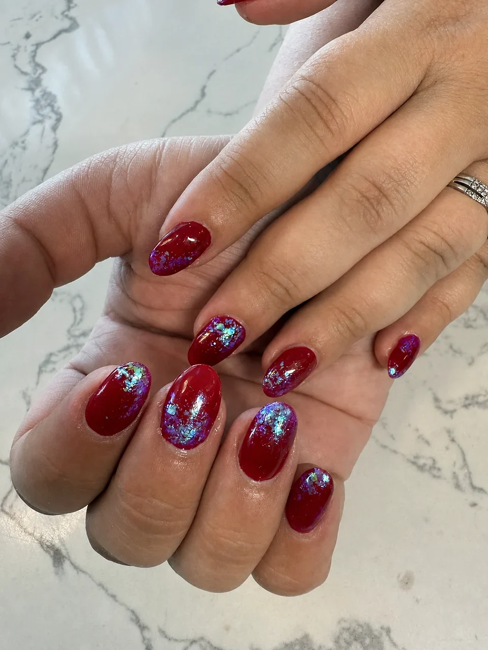 Deep red nails with iridescent foil